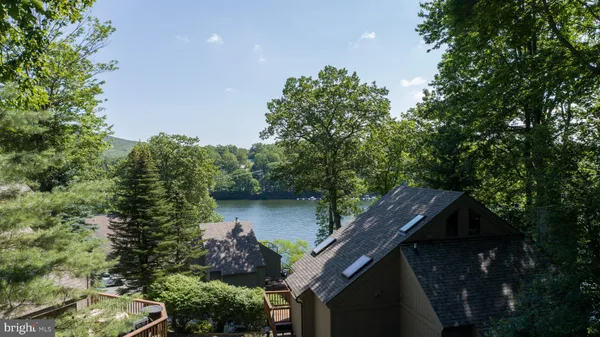 a balcony with wooden floor and yard in the back