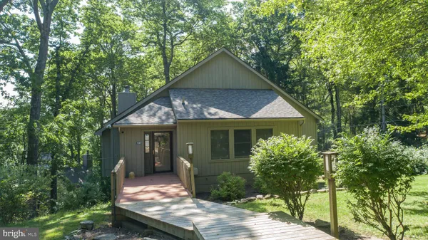 an aerial view of a house with a yard and outdoor seating