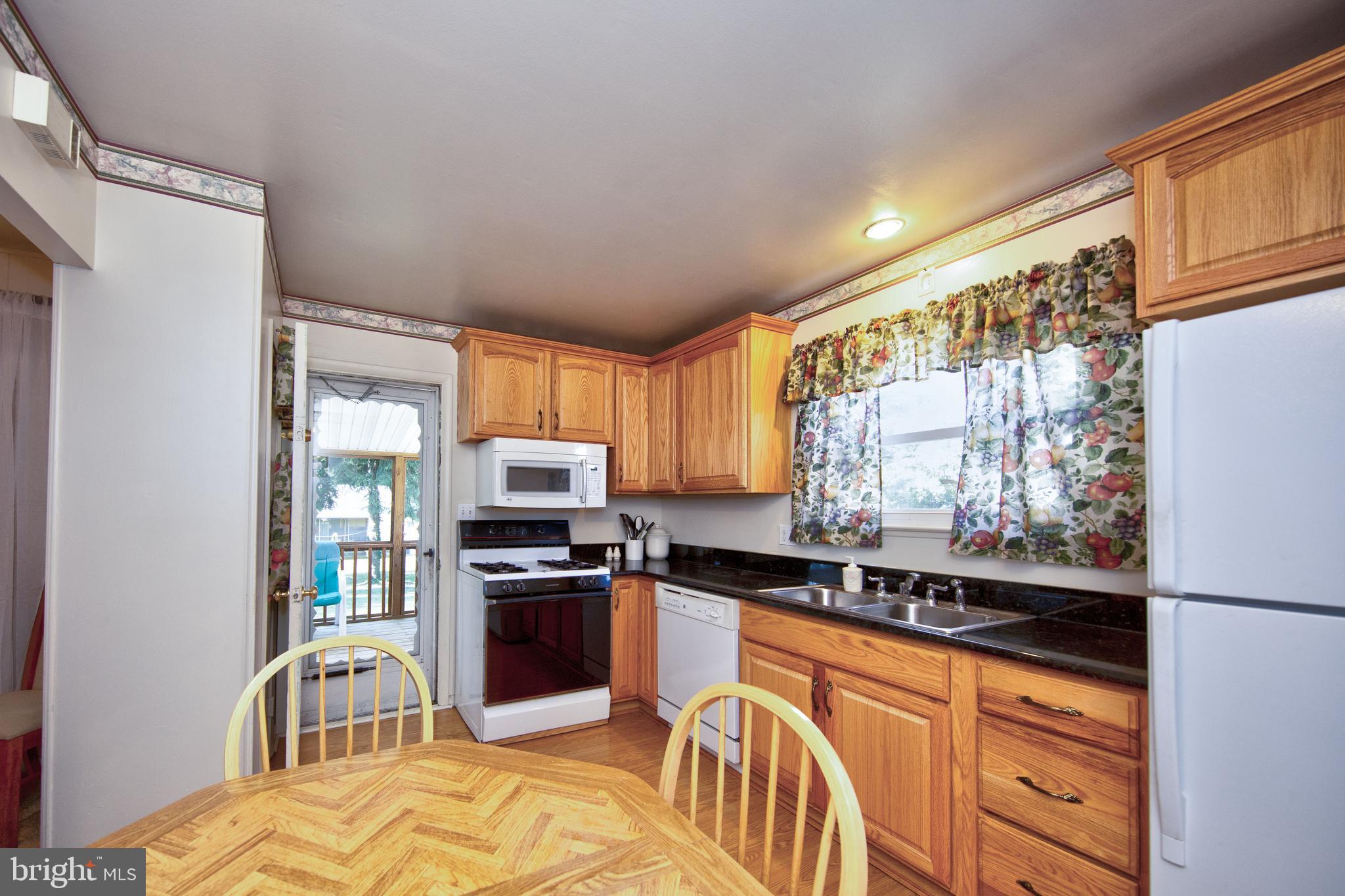 6119 Deerbrook Road Baltimore, MD 21228 - Photo 11 of 28 Kitchen w/ door leading to screened in porch
