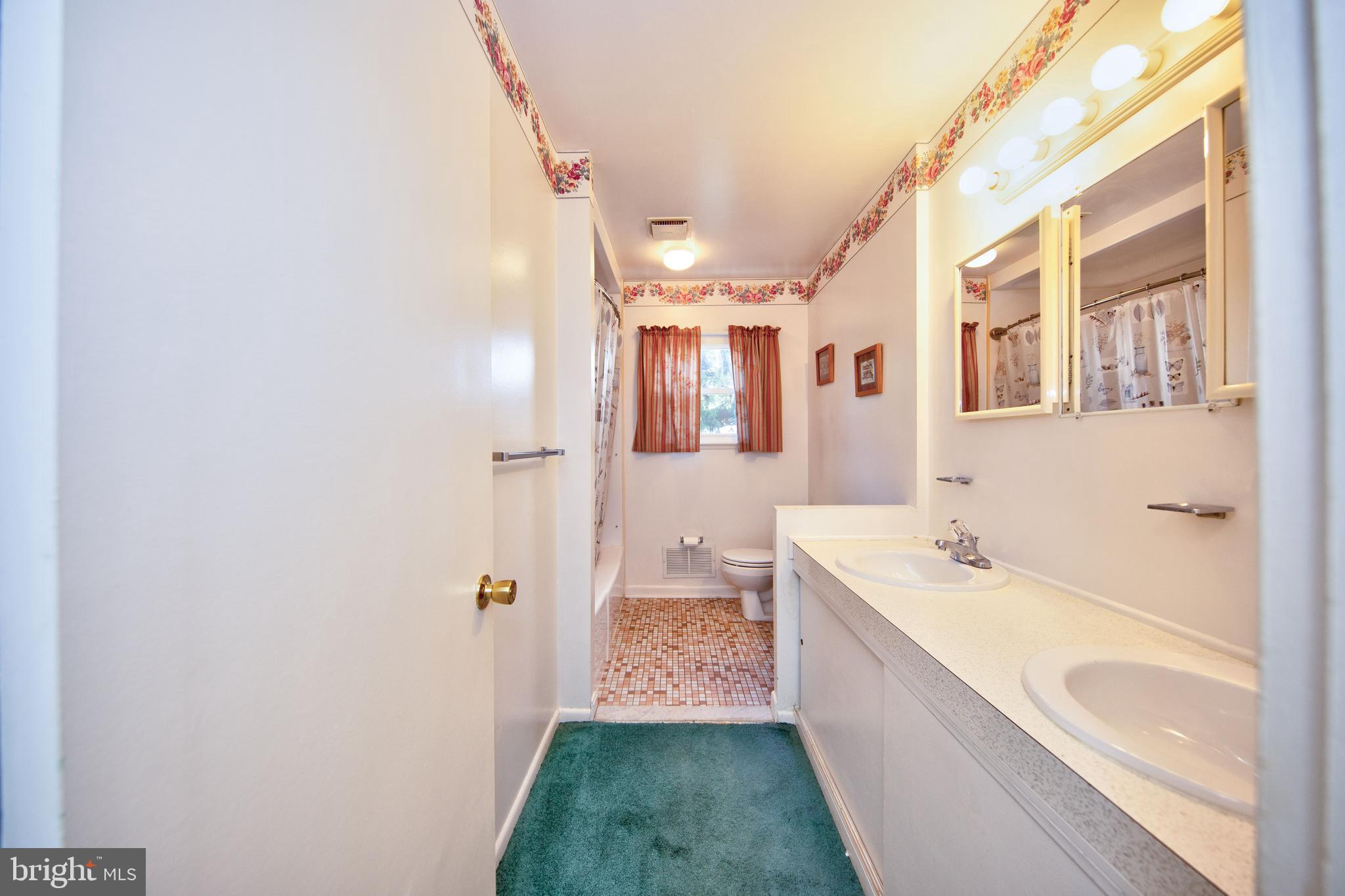 6119 Deerbrook Road Baltimore, MD 21228 - Photo 16 of 28 Full bathroom on main level w/ double vanity