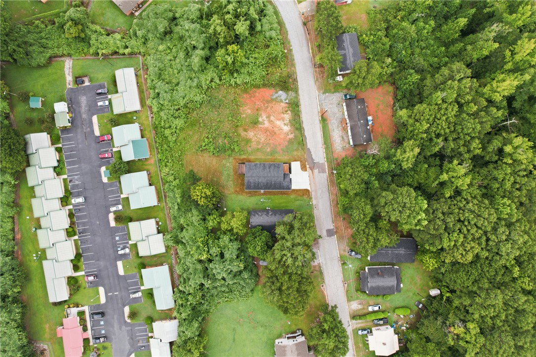 403 Tribble Street Seneca, SC 29678 - Photo 31 of 37 An aerial perspective reveals a verdant landscape surrounding a community with ample parking.