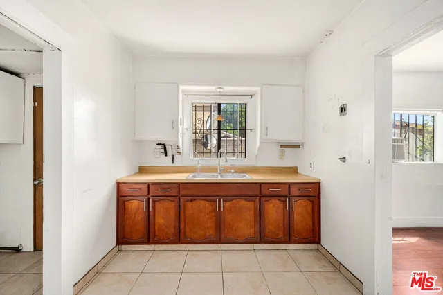 a spacious bathroom with a sink a mirror and a bathtub