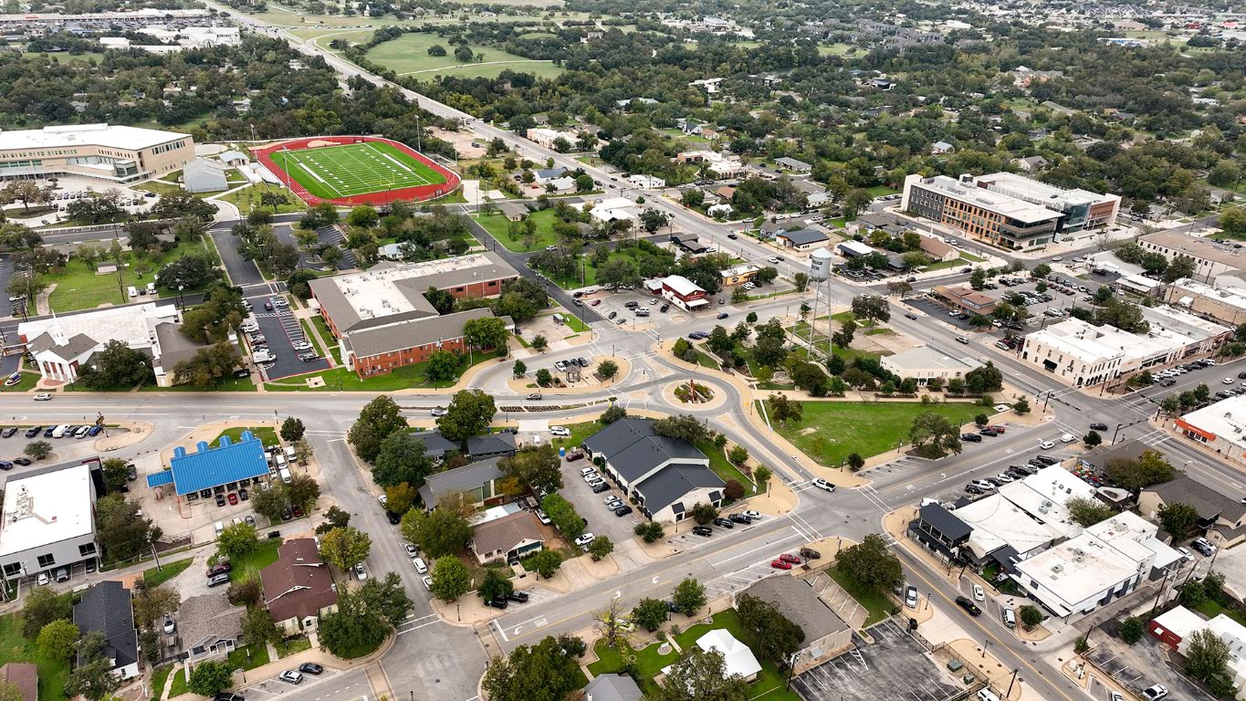 2605 Sam Bass Road, Unit 107 Round Rock, TX 78681 - Photo 7 of 11 an aerial view of residential houses with outdoor space