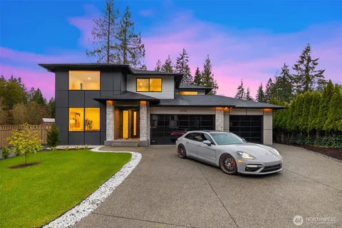 a view of a car parked in back yard of a house