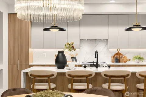 a dining room with furniture a chandelier and wooden floor
