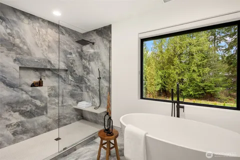 a bathroom with a shower sink and mirror