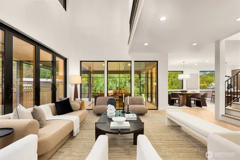 a living room with furniture and large windows