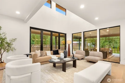 a living room with furniture and floor to ceiling windows
