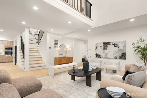 a living room with furniture and stairs