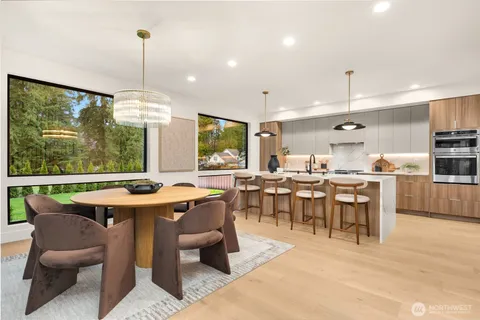 a large kitchen with a table and chairs