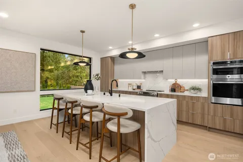a kitchen with kitchen island a large counter space and stainless steel appliances