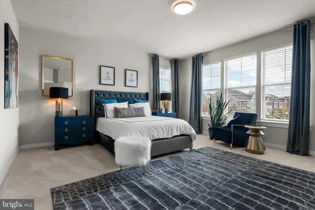 a bedroom with a bed and a potted plant on the dresser