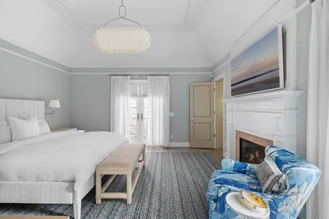 a bedroom with a bed and a fireplace