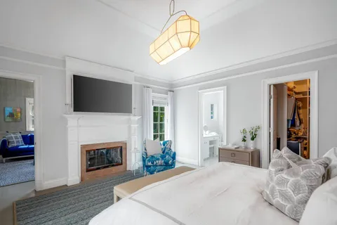 a bedroom with a bed and a flat screen tv