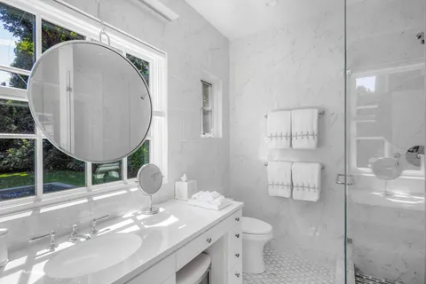 a bathroom with a sink mirror and toilet
