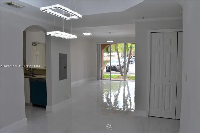 a view of kitchen and dining room with chandelier