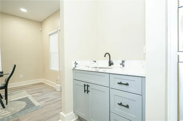 a large white kitchen with a large window