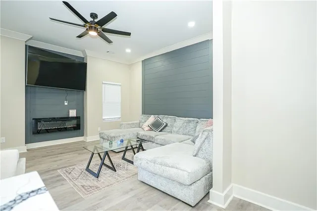 a kitchen with stainless steel appliances a refrigerator a sink a stove a table and chairs