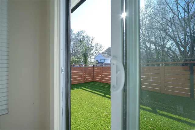 a view of a backyard with wooden fence