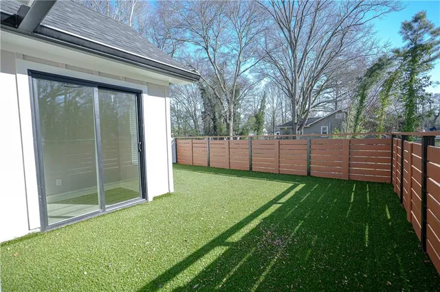 a view of backyard of house and garden