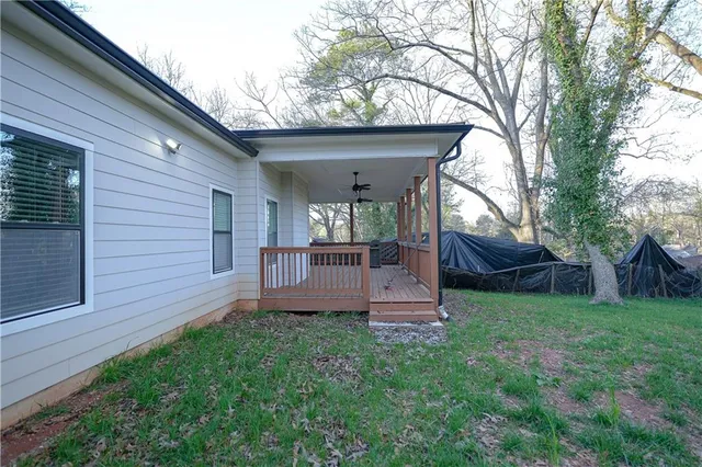 a view of a chair and table in backyard of the house