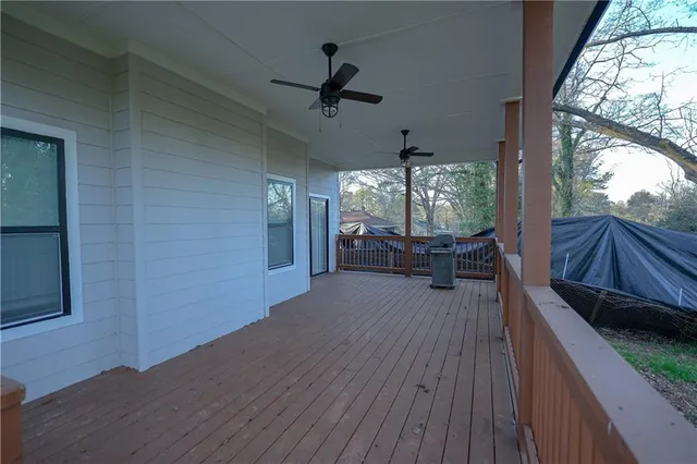 a view of a balcony with furniture and wooden floor