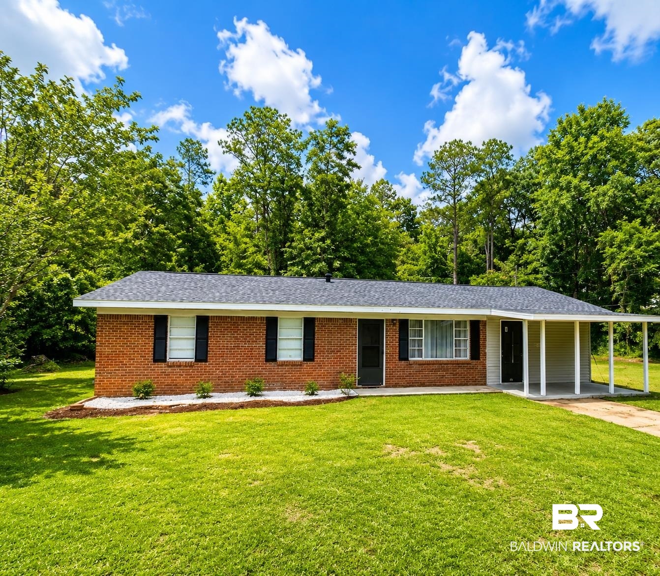 226 Elizabeth Street Evergreen, AL 36401 - Photo 3 of 35 Brick exterior with black shutters and a covered porch