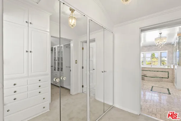 a view of walk in closet with hardwood floor