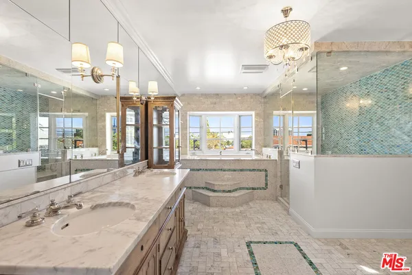 a large bathroom with a large tub and sink