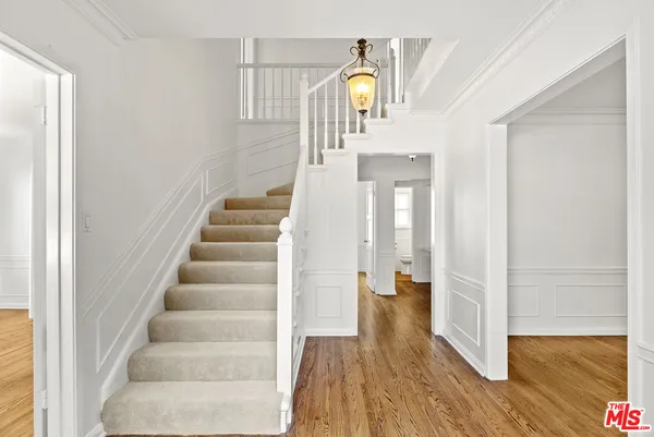 a view of entryway and hall with wooden floor