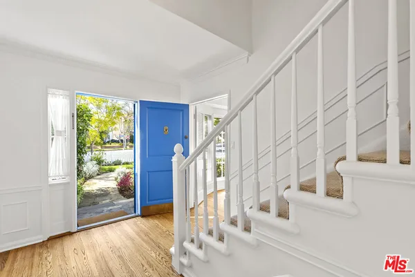 a view of entryway with wooden floor and door