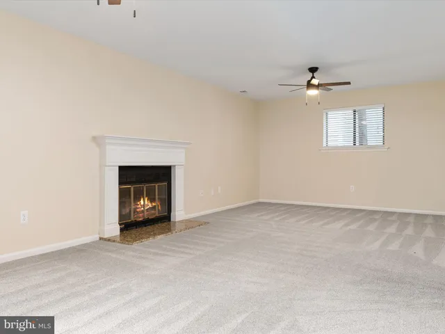 a view of an empty room with a fireplace