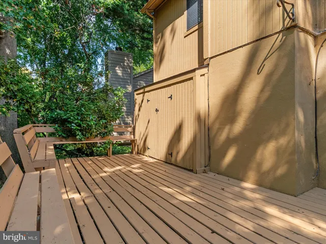 a view of balcony with wooden floor and bench