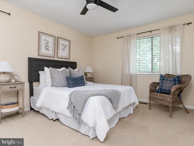 a spacious bedroom with a bed and a couch