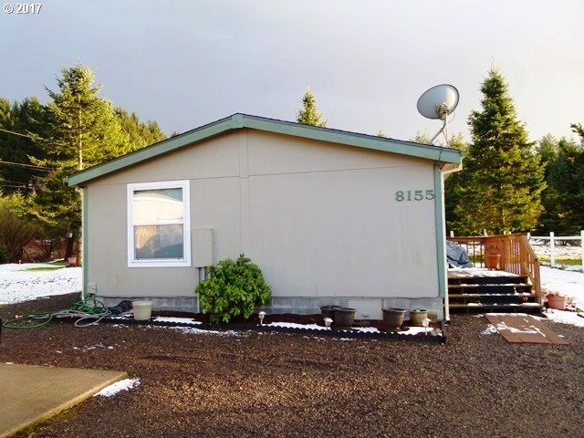 8155 Burbank Road Tillamook, OR 97141 - Photo 5 of 21 a front view of a house with a yard