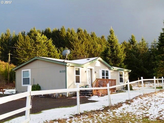 8155 Burbank Road Tillamook, OR 97141 - Photo 6 of 21 a view of a white house with a patio