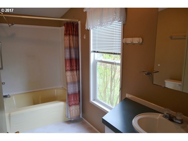 8155 Burbank Road Tillamook, OR 97141 - Photo 10 of 21 a bathroom with a tub and a sink