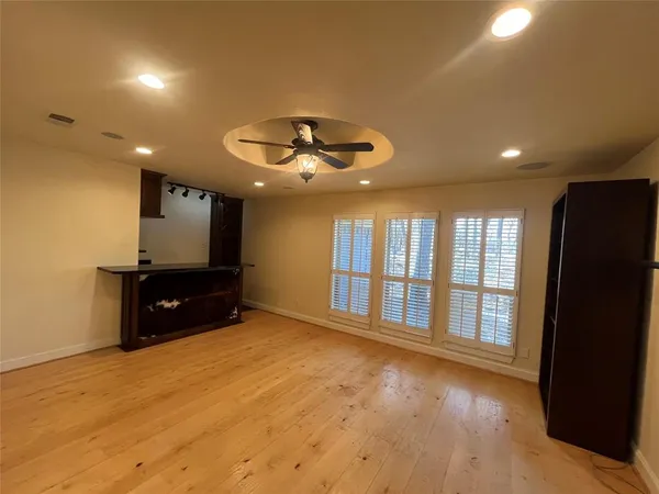 a view of a hallway with wooden shelves