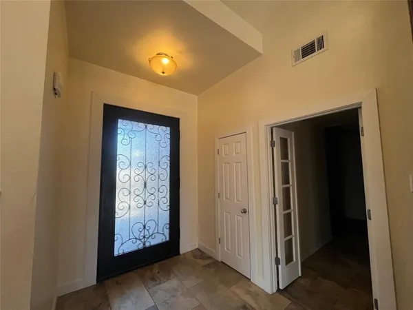 a view of an empty room with wooden shelves