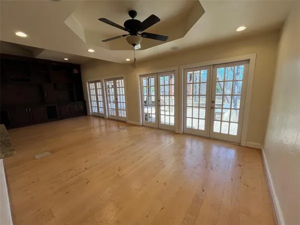 a view of wooden floor and windows in a room