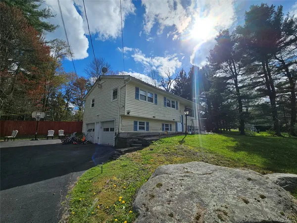 a front view of a house with a yard and pathway