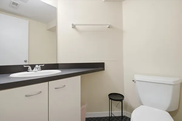 a bathroom with a toilet a sink and a mirror