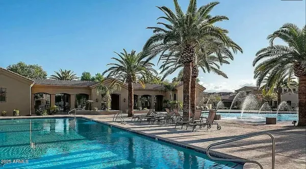 a view of a house with swimming pool and a sitting area