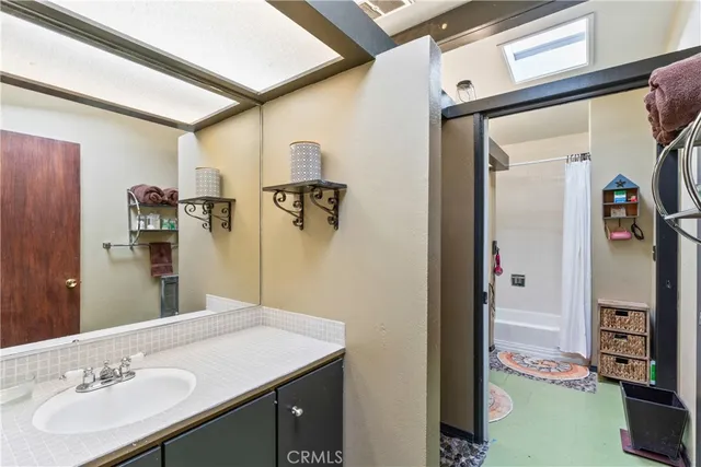 a bathroom with a double vanity sink a toilet and a shower