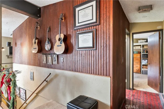 a view of house with wooden deck and outdoor seating