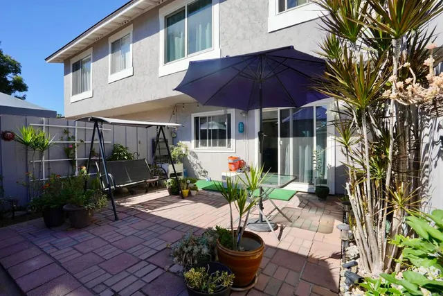 a view of a house with sitting area and garden