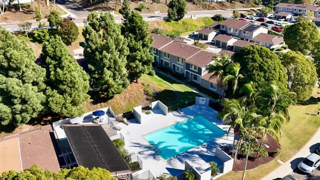 an aerial view of a house with a yard and lake view