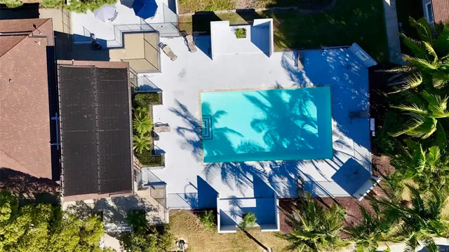 an aerial view of a house with a yard and potted plants