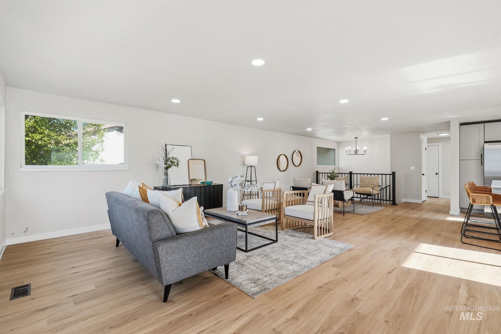 1990 Panama Street Boise, ID 83705 - Photo 11 of 50 Spacious living area featuring light wood-finish flooring, recessed lighting, and ample natural light from a large window