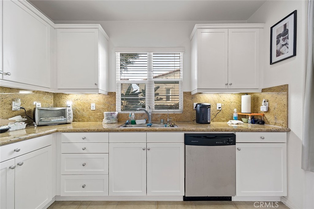 876 Sunset Place Diamond Bar, CA 91765 - Photo 9 of 17 a kitchen with granite countertop white cabinets and white appliances
